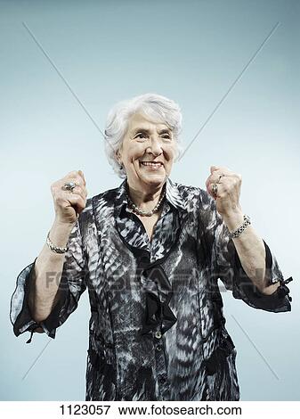 A senior woman with her arms raised in celebration View Large Photo Image Stock Photo - A senior woman with her arms raised in celebration. Fotosearch