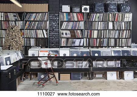 A shopping cart and rows of records on shelves and in bins at a record store View Large Photo Image Stock Photo - A shopping cart and rows of records on shelves and in bins at a record store. Fotosearch