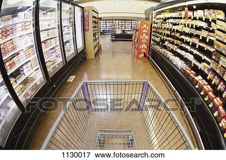 A shopping cart on an aisle in a supermarket, personal perspective View Large Photo Image Stock Photo - A shopping cart on an aisle in a supermarket, personal perspective. Fotosearch