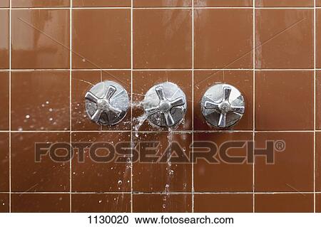 A shower faucet handle spraying leaking water View Large Photo Image Stock Image - A shower faucet handle spraying leaking water. Fotosearch