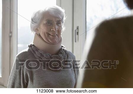 A smiling senior woman wearing a neck brace View Large Photo Image Stock Photo - A smiling senior woman wearing a neck brace. Fotosearch