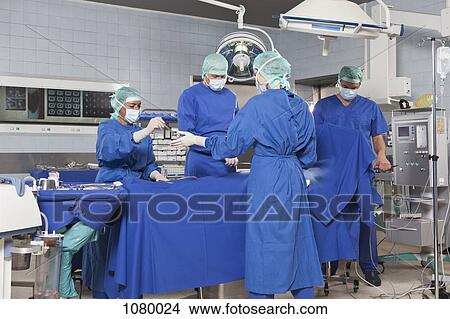 Picture - A surgery team operating on a patient in an operating room. Fotosearch