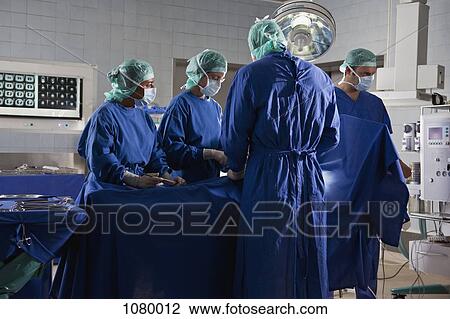 A surgery team operating on a patient in an operating room View Large Photo Image Stock Image - A surgery team operating on a patient in an operating room. Fotosearch