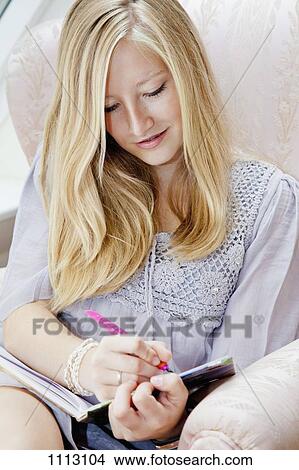 A teenage girl writing in her diary View Large Photo Image Picture - A teenage girl writing in her diary. Fotosearch