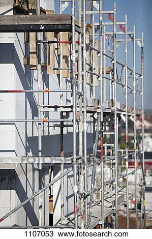 A tilt-shift shot of scaffolding on a building under construction View Large Photo Image Stock Image - A tilt-shift shot of scaffolding on a building under construction. Fotosearch