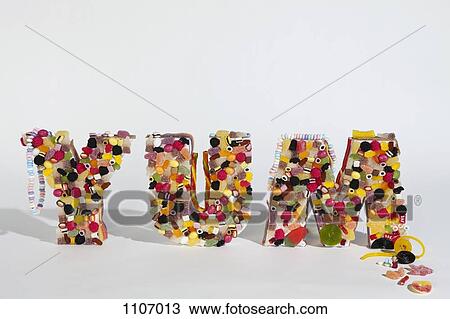 Stock Image - A variety of candy molded into the word YUM. Fotosearch