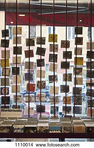 A window display of hanging compact discs in a record shop View Large Photo Image Picture - A window display of hanging compact discs in a record shop. Fotosearch
