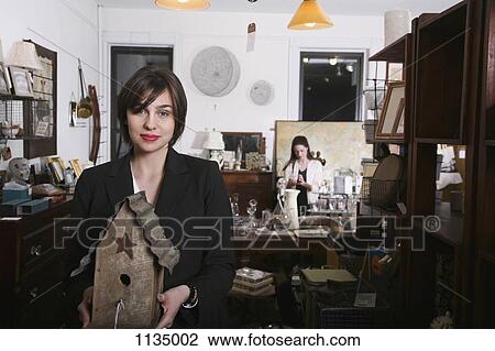 A woman holding an old birdhouse in an antiques shop View Large Photo Image Stock Image - A woman holding an old birdhouse in an antiques shop. Fotosearch