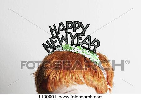 A woman wearing a party tiara with Happy New Year on it, top of head View Large Photo Image Stock Image - A woman wearing a party tiara with Happy New Year on it, top of head. Fotosearch