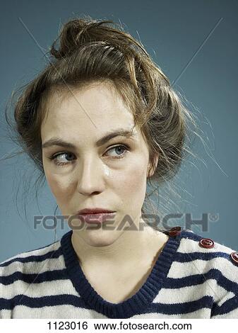 Stock Photograph - A woman with a tear running down her face. Fotosearch