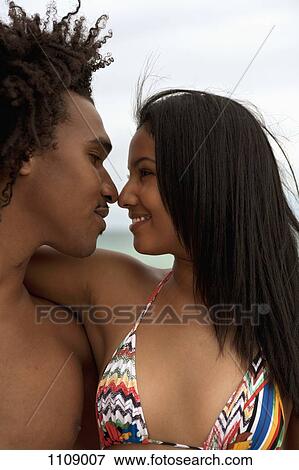 A young couple with arms around each other View Large Photo Image Stock Photo - A young couple with arms around each other. Fotosearch