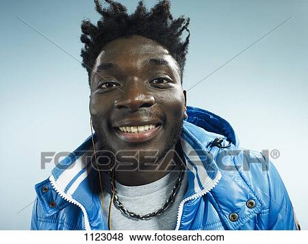 A young man wearing a vintage ski jacket and earbuds View Large Photo Image Stock Photo - A young man wearing a vintage ski jacket and earbuds. Fotosearch