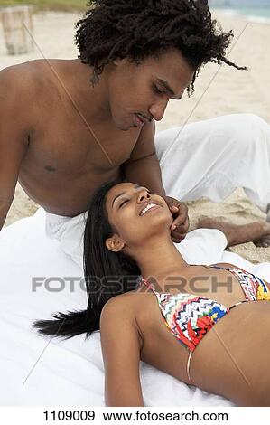 An affectionate young couple at the beach View Large Photo Image Stock Photo - An affectionate young couple at the beach. Fotosearch