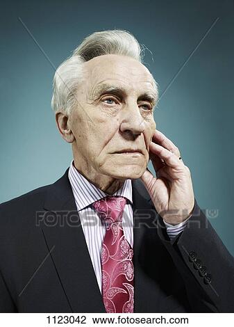 Stock Image - An elegant senior man looking away with a worried expression. Fotosearch