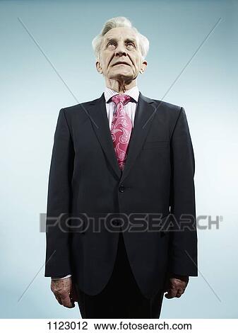 An elegant senior man wearing a suit and pink paisley tie View Large Photo Image Stock Image - An elegant senior man wearing a suit and pink paisley tie. Fotosearch
