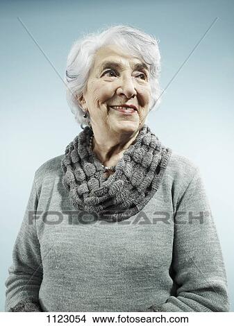 An elegant senior woman smiling and looking away View Large Photo Image Picture - An elegant senior woman smiling and looking away. Fotosearch