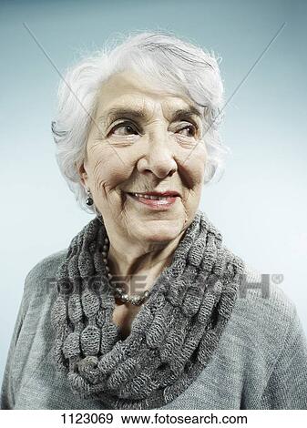 An elegant senior woman smiling and looking away View Large Photo Image Stock Photo - An elegant senior woman smiling and looking away. Fotosearch