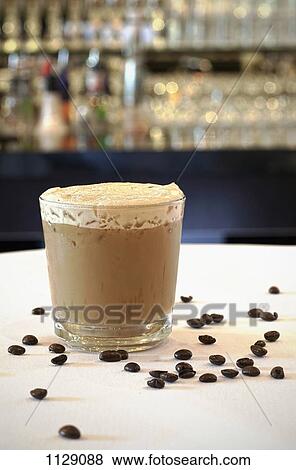 An iced coffee on a table View Large Photo Image Stock Photo - An iced coffee on a table. Fotosearch