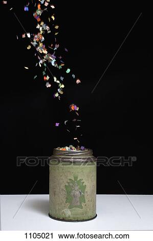 An old-fashioned metal tin and floating confetti View Large Photo Image Stock Image - An old-fashioned metal tin and floating confetti. Fotosearch