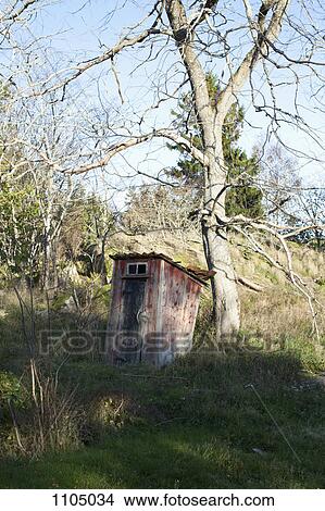 Picture - An outhouse on a hill. Fotosearch