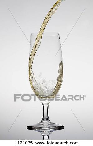 Beer being poured into a glass View Large Photo Image Stock Photography - Beer being poured into a glass. Fotosearch