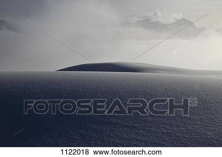 Blanket of snow with cloudy mountains in the background View Large Photo Image Stock Photo - Blanket of snow with cloudy mountains in the background. Fotosearch
