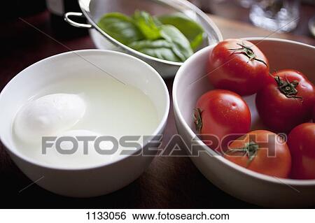 Bowls of mozzarella, tomatoes and basil View Large Photo Image Stock Photograph - Bowls of mozzarella, tomatoes and basil. Fotosearch
