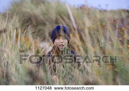 Boy among the beach grass View Large Photo Image Stock Photo - Boy among the beach grass. Fotosearch