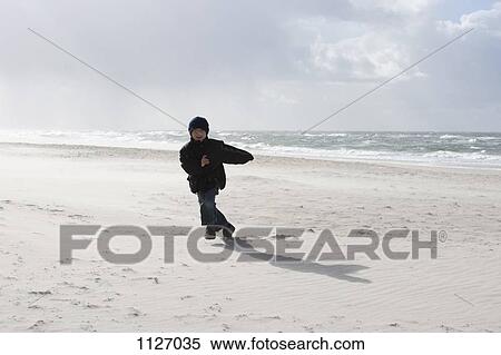 Boy running on the beach View Large Photo Image Stock Photography - Boy running on the beach. Fotosearch