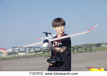 Boy with model airplane at the abandoned airfield at Tempelhof Airport, Berlin View Large Photo Image Stock Image - Boy with model airplane at the abandoned airfield at Tempelhof Airport, Berlin. Fotosearch