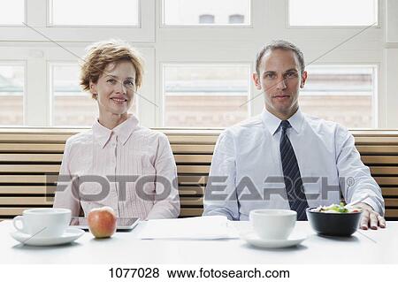 Stock Photo - Business colleagues having a business lunch. Fotosearch