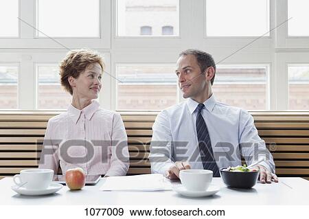 Business colleagues having lunch together View Large Photo Image Stock Photo - Business colleagues having lunch together. Fotosearch