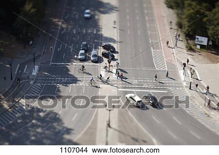 Picture - Cars, bicyclists and pedestrians at crossing, tilt-shift, Berlin, Germany. Fotosearch