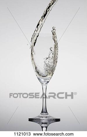 Champagne being poured into a glass View Large Photo Image Stock Image - Champagne being poured into a glass. Fotosearch