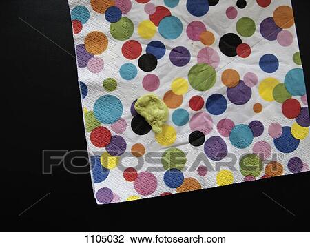 Stock Image - Chewed gum on a polka dot napkin. Fotosearch