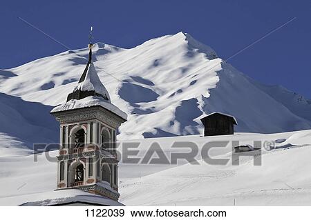 Church tower and snowy mountain in background View Large Photo Image Stock Photo - Church tower and snowy mountain in background. Fotosearch