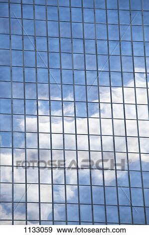 Clouds and sky reflected in mirrored windows of an office building View Large Photo Image Stock Photo - Clouds and sky reflected in mirrored windows of an office building. Fotosearch