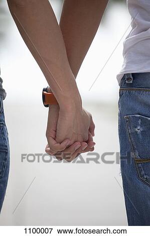 Stock Photo - Couple holding hands. Fotosearch