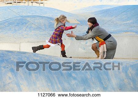 Daughter runs towards Mother in park View Large Photo Image Stock Photograph - Daughter runs towards Mother in park. Fotosearch