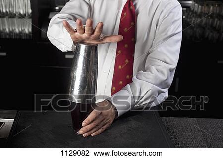 Detail of a bartender making a drink, midsection View Large Photo Image Stock Image - Detail of a bartender making a drink, midsection. Fotosearch