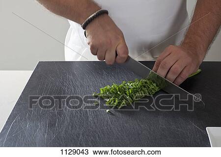 Detail of a man chopping fresh herbs View Large Photo Image Stock Image - Detail of a man chopping fresh herbs. Fotosearch