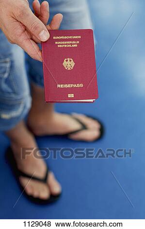 Detail of a man holding a German passport View Large Photo Image Stock Photo - Detail of a man holding a German passport. Fotosearch