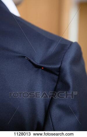 Stock Image - Detail of a pin in the shoulder of a suit jacket. Fotosearch