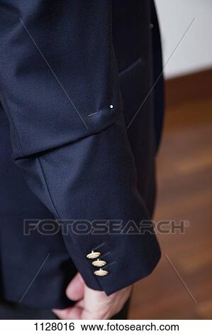 Detail of a pin in the sleeve of a man's suit jacket View Large Photo Image Stock Photograph - Detail of a pin in the sleeve of a man's suit jacket. Fotosearch