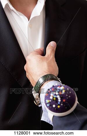 Detail of a tailor adjusting a suit on a man View Large Photo Image Stock Image - Detail of a tailor adjusting a suit on a man. Fotosearch