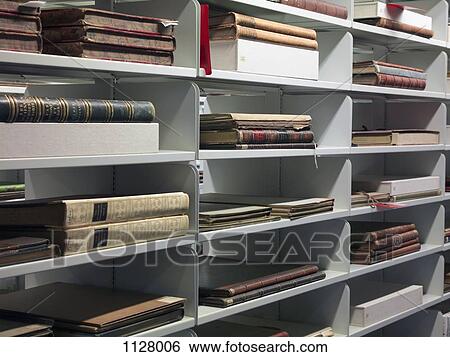 Detail of old books on shelves in a library View Large Photo Image Stock Photograph - Detail of old books on shelves in a library. Fotosearch