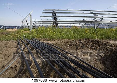 Detail of pipes and solar panels being installed in a field View Large Photo Image Stock Photograph - Detail of pipes and solar panels being installed in a field. Fotosearch