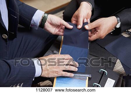 Detail of two men holding fabric samples View Large Photo Image Stock Photo - Detail of two men holding fabric samples. Fotosearch