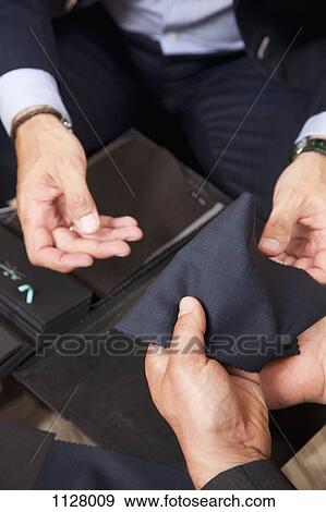 Detail of two men holding fabric samples View Large Photo Image Stock Photo - Detail of two men holding fabric samples. Fotosearch