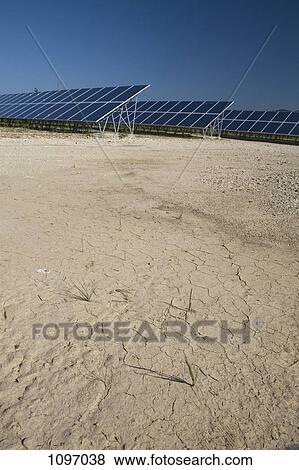 Dry ground next to rows of solar panels in a field View Large Photo Image Stock Photo - Dry ground next to rows of solar panels in a field. Fotosearch
